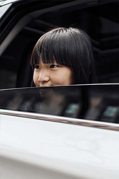 A girl looking out of the window of a car